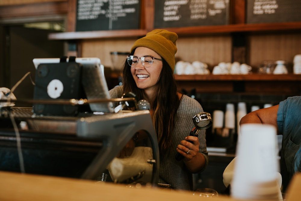 Café owner smiling behind the counter