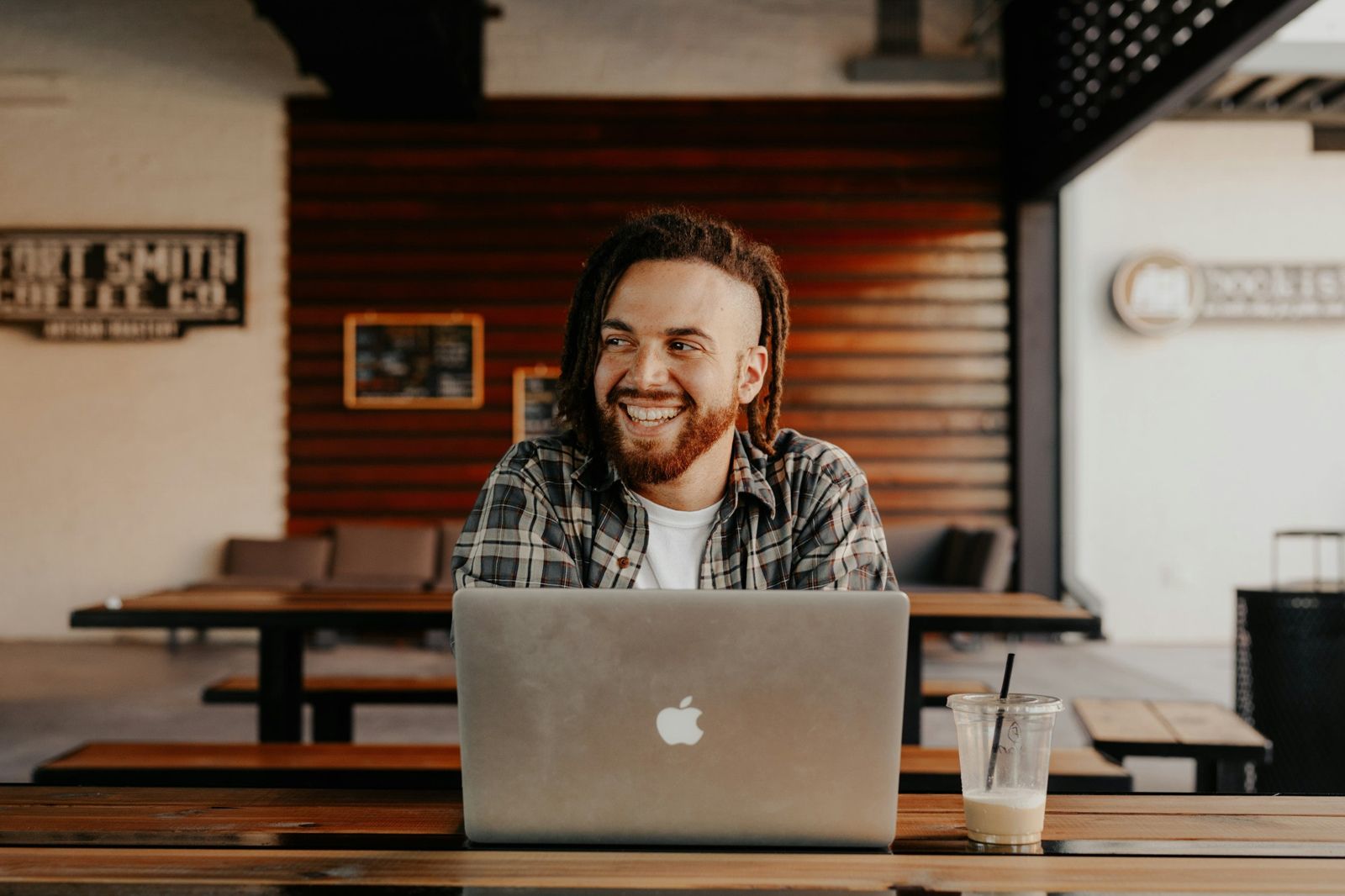 A sales executive working on a laptop in a café